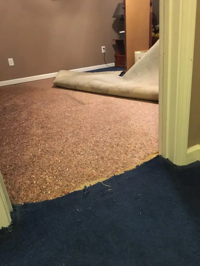 Carpet pad removal revealing water damage during Water Mitigation Services in Oxnard